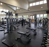 fitness equipment spread out in a room with a large vaulted ceiling