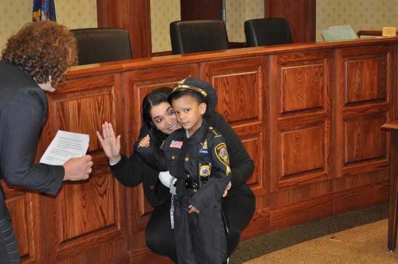Officer Ethan being sworn in by Mayor Brown