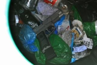 Photo of gun located in trash can