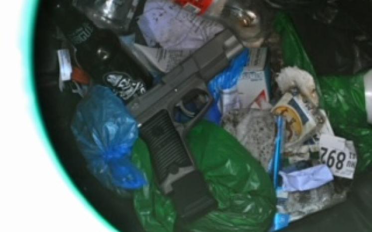 Photo of gun located in trash can